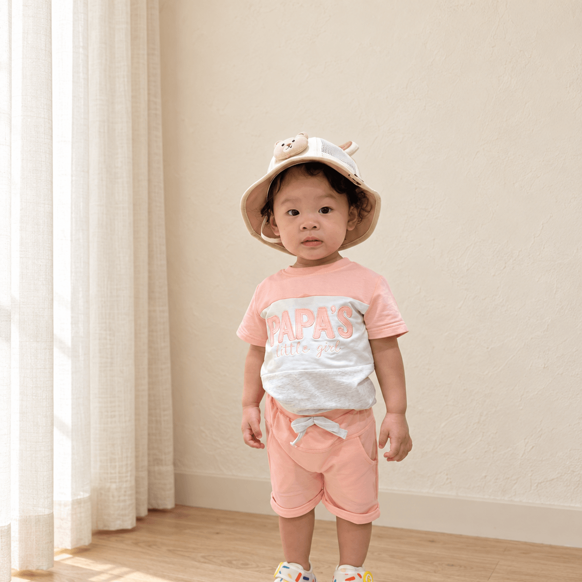Child wearing the coral Papa’s Little Girl Colorblock Short-Sleeve Set